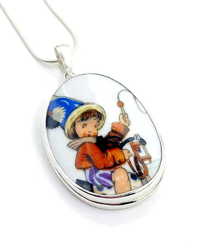 Child Riding Toy Horse Pendant on Silver Chain